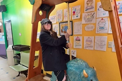 Justine Cabell riding a small blue buffalo