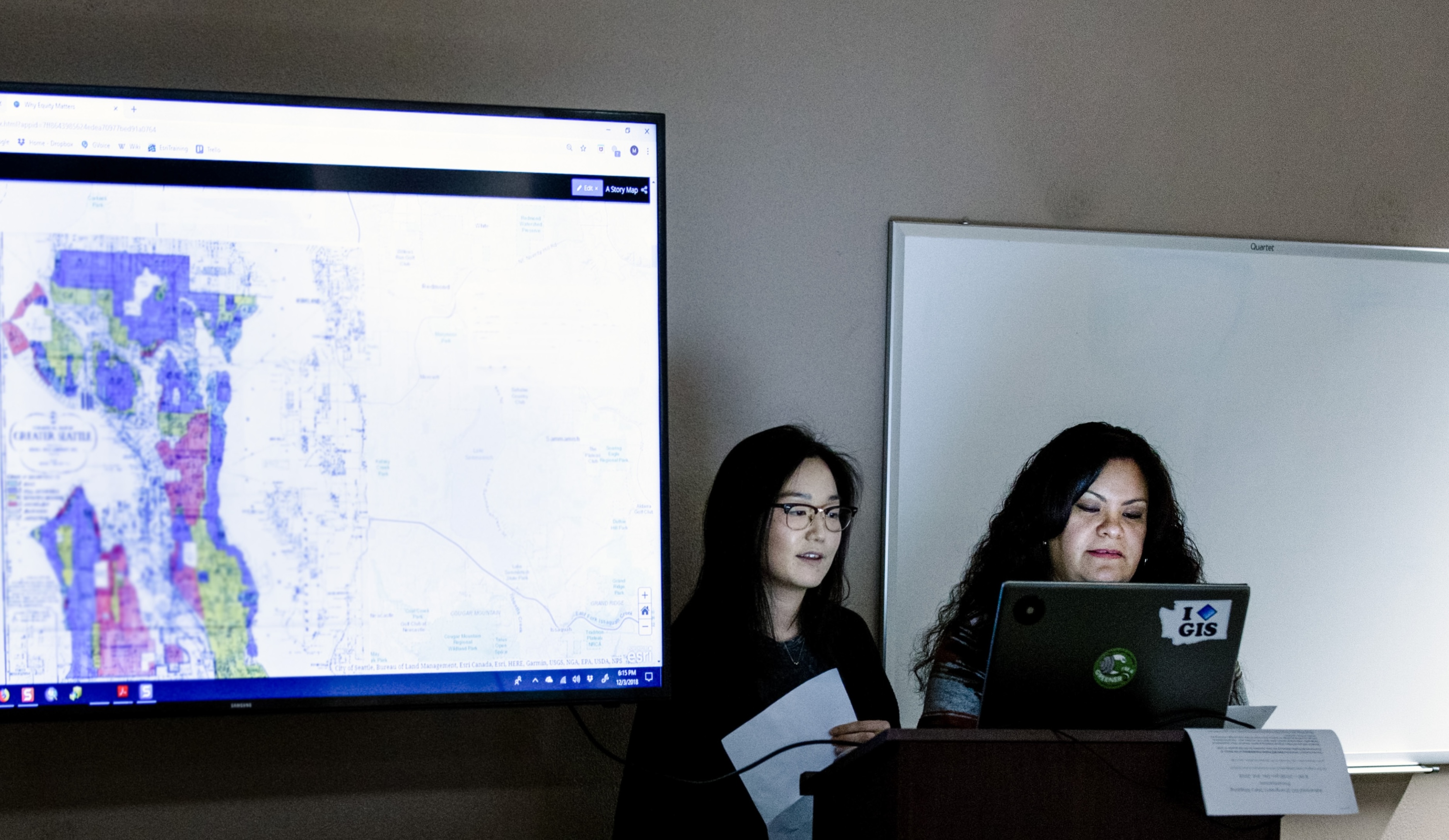 two people present GIS maps