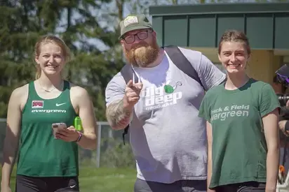 zeb hoffman with two track and field students