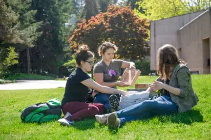 students outside demonstrating asexual plant propagation 