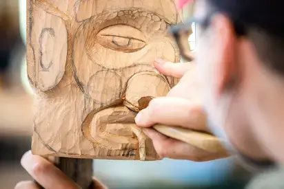 Artist carving in a studio