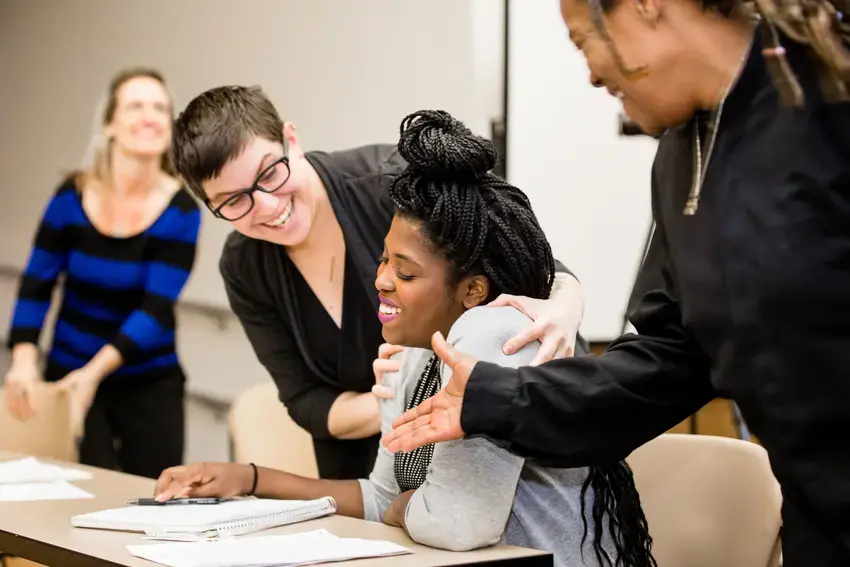 students around a table laughing