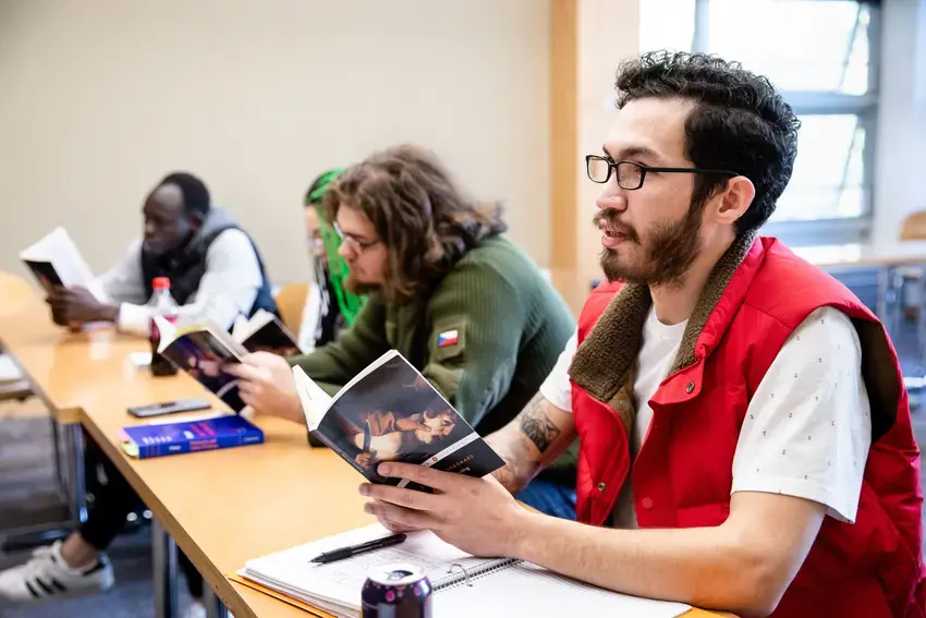 profile of students sitting a long a table 