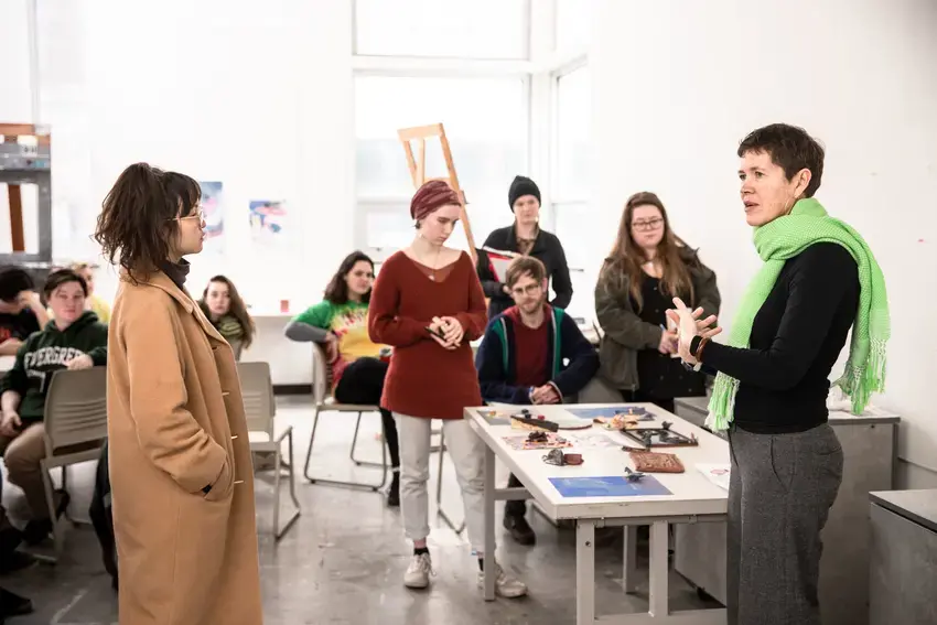 a group of students and a professor having a group discussion 