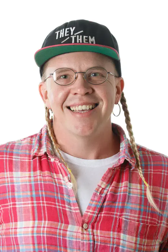 Photo of a person wearing glasses and a baseball cap